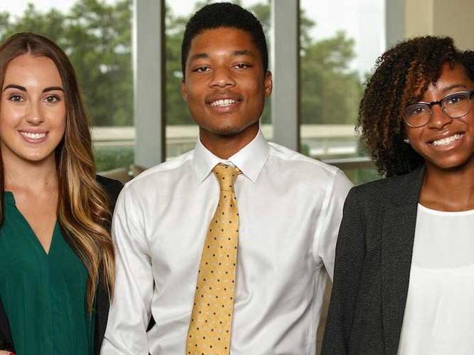 A group of business students smiling for picture