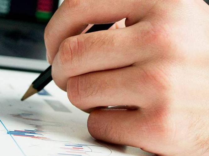 Student hovering over graph with pencil