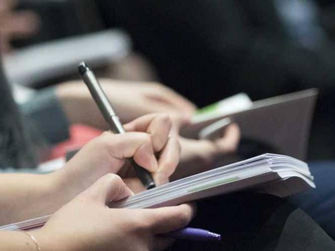 A student taking notes in their journal